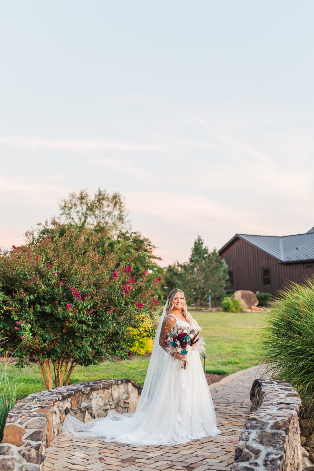 Bride with bouquet at a stone bridge